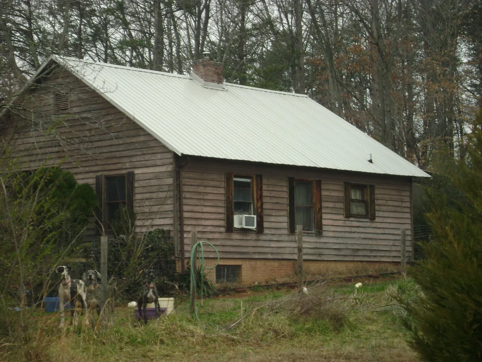 White metal roof on an old wood sided farmhouse, from a Metal Roof Installation job in Unionville
